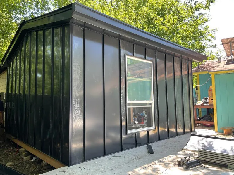 Black standing seam metal wall panels for Roof Inspection in Palmview