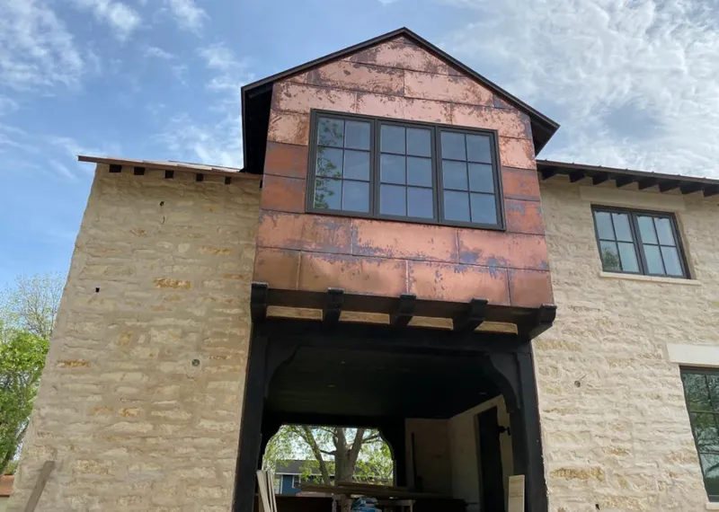 Copper metal panel facade on a stone building for Metal Roof Coating in Palmview