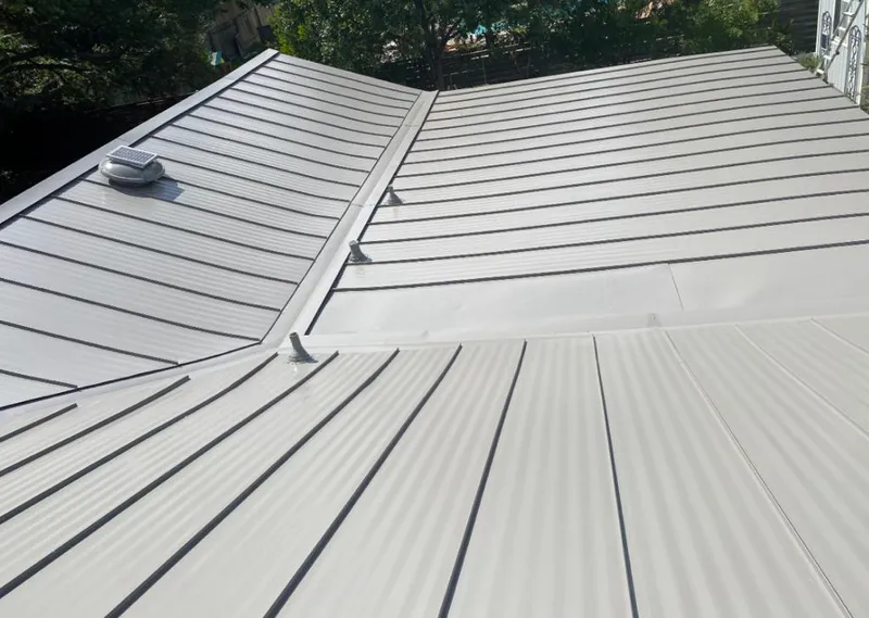 Solar attic fan installed on a metal roof for Roof Ventilation in Palmview